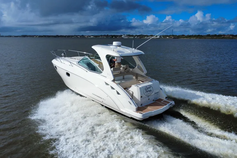Slide: The Image of 2011 Chaparral 310 Signature cruising on open water under cloudy skies. - 2