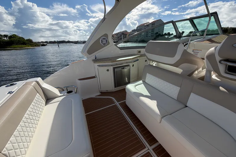 Slide: The Image of Luxurious interior of 2011 Chaparral 310 Signature boat with plush seating and scenic water view. - 12