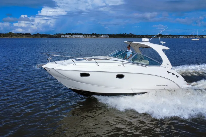 The Image of Chaparral 310 Signature 2011 cruising on a calm lake under a blue sky. - 0