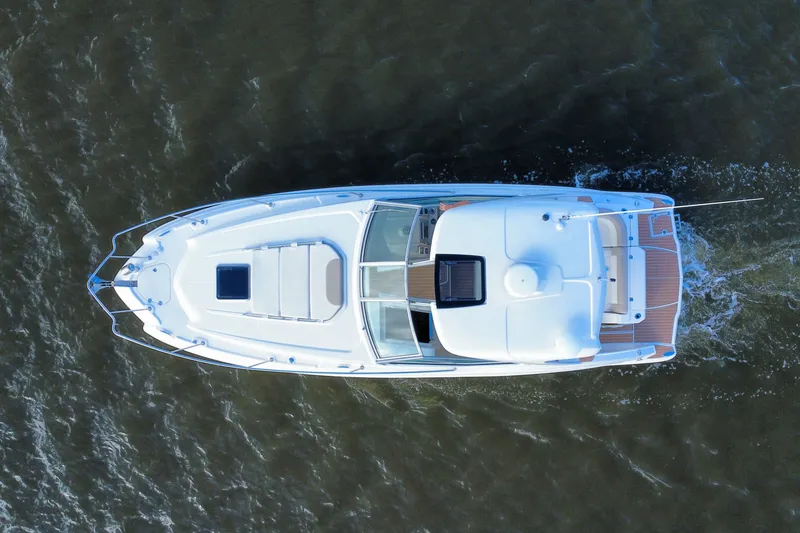 Slide: The Image of Aerial view of 2011 Chaparral 310 Signature boat cruising on water. - 8