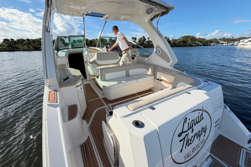 Slide: The Image of 2011 Chaparral 310 Signature boat on water, featuring spacious deck and seating area. - 15