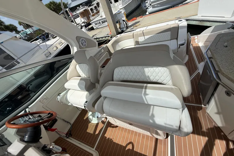 Slide: The Image of Interior of 2011 Chaparral 310 Signature boat with luxurious seating and steering wheel. - 26