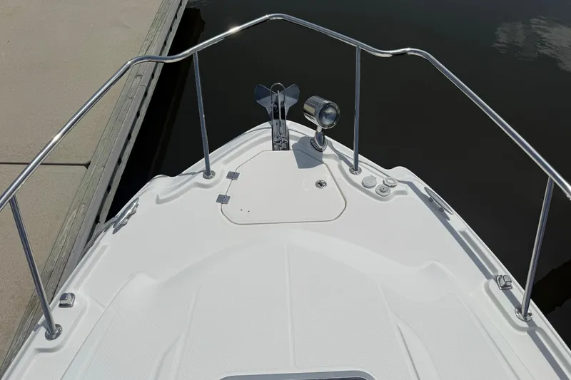 Slide: The Image of Bow view of 2011 Chaparral 310 Signature boat docked at marina. - 11