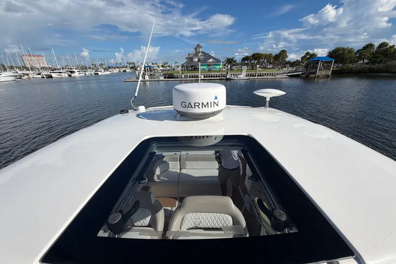 Slide: The Image of 2011 Chaparral 310 Signature yacht with Garmin equipment, docked at a marina under a blue sky. - 29