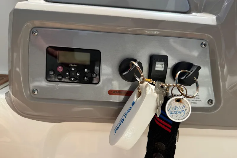 Slide: The Image of Control panel of a 2011 Chaparral 310 Signature boat with keys and keychains. - 34