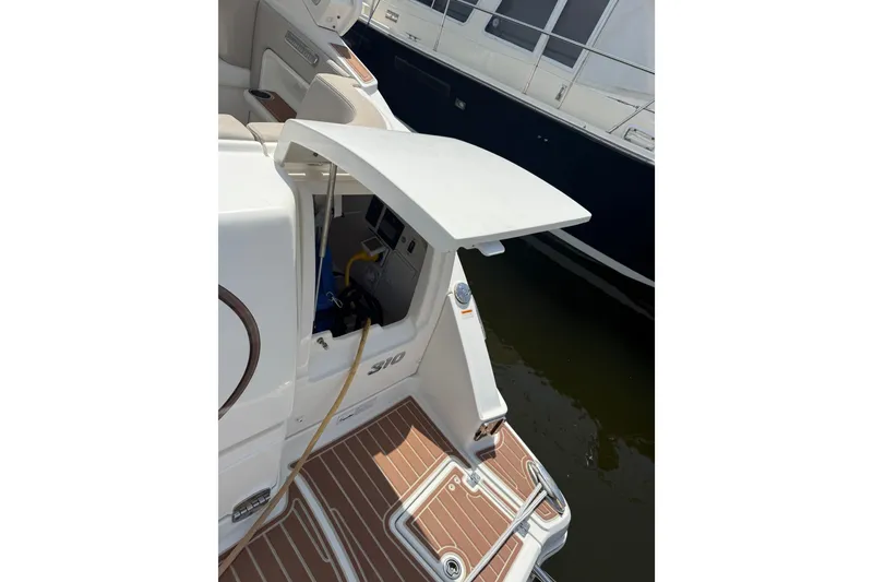 Slide: The Image of 2011 Chaparral 310 Signature boat with open hatch and visible deck details. - 46