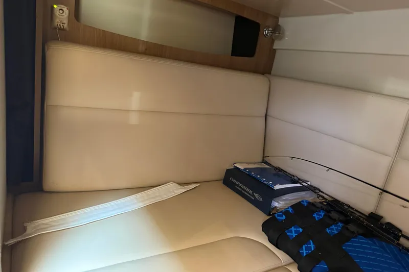 Slide: The Image of Interior of 2011 Chaparral 310 Signature boat with beige seating and fishing gear. - 41