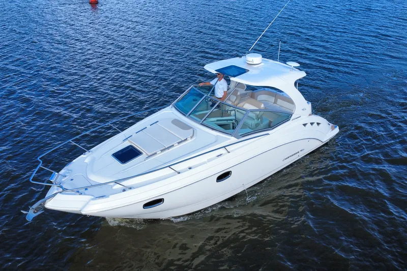 Slide: The Image of 2011 Chaparral 310 Signature cruising on open water, showcasing sleek design and luxury features. - 3