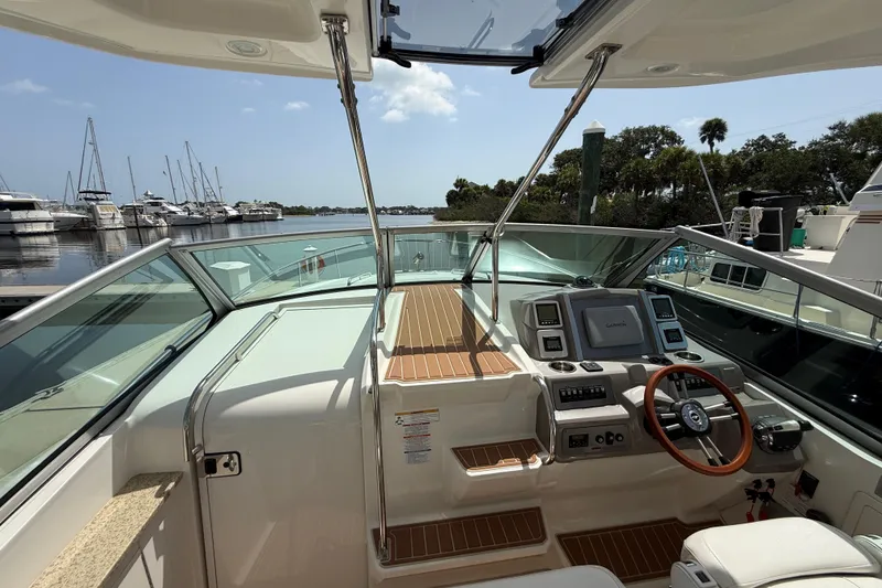 Slide: The Image of 2011 Chaparral 310 Signature boat cockpit with steering wheel and navigation system. - 18