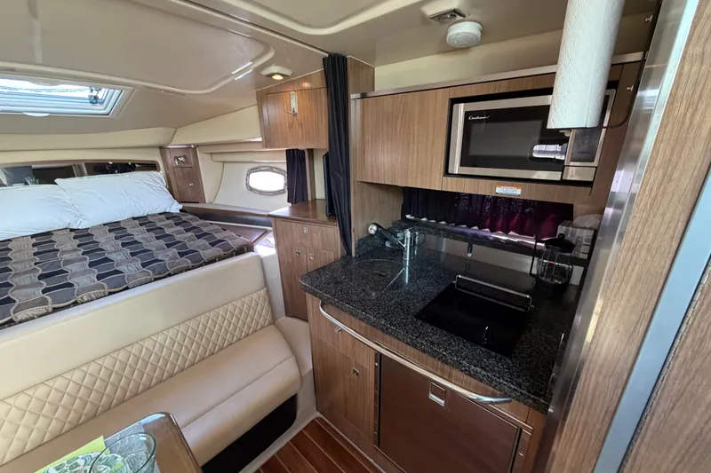 Slide: The Image of Interior of 2011 Chaparral 310 Signature yacht with kitchenette and sleeping area. - 21