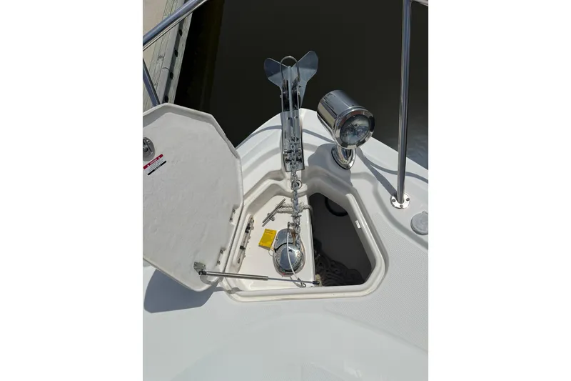 Slide: The Image of 2011 Chaparral 310 Signature boat anchor compartment with open hatch and spotlight. - 10