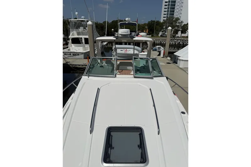 Slide: The Image of 2011 Chaparral 310 Signature boat docked at marina, view from bow. - 12