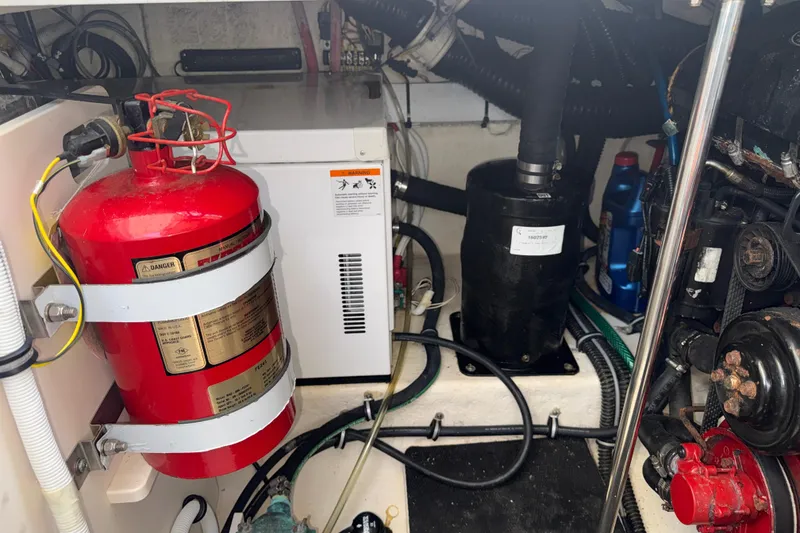 Slide: The Image of Engine compartment of a 2011 Chaparral 310 Signature boat with fire extinguisher and equipment. - 51