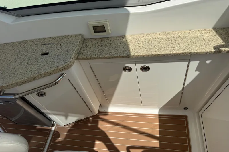 Slide: The Image of 2011 Chaparral 310 Signature boat interior with granite countertop and wooden flooring. - 20