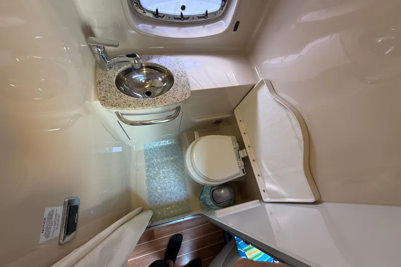 Slide: The Image of 2011 Chaparral 310 Signature boat bathroom with sink, toilet, and window. - 44