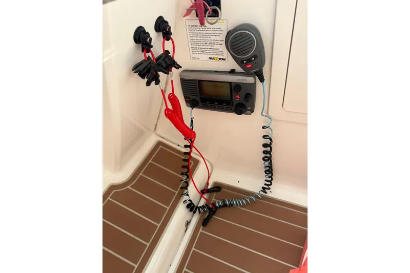Slide: The Image of 2011 Chaparral 310 Signature boat interior with Garmin VHF radio and microphone. - 33