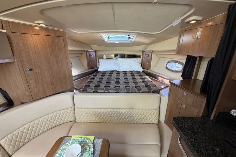 Slide: The Image of Luxurious interior of 2011 Chaparral 310 Signature boat with cozy bed and seating area. - 19
