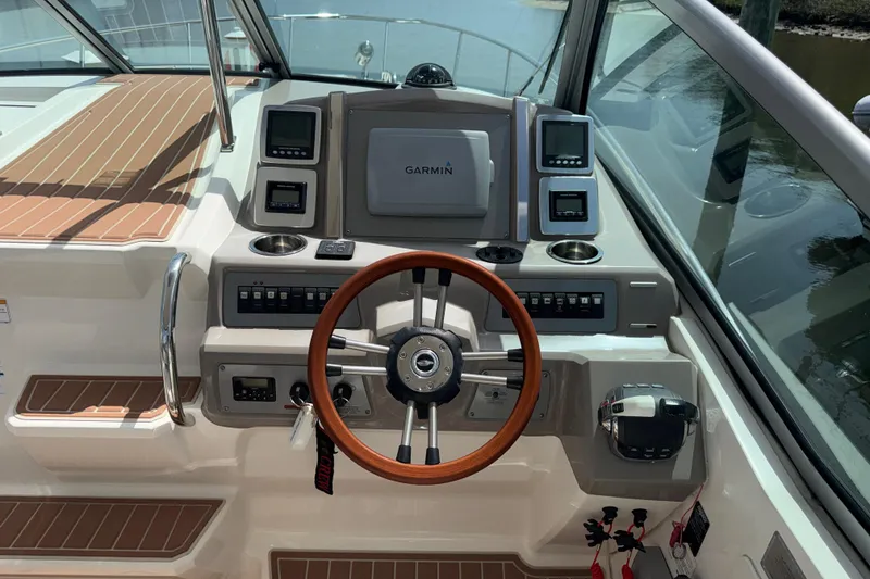 Slide: The Image of 2011 Chaparral 310 Signature boat helm with Garmin navigation and wood-accented steering wheel. - 27