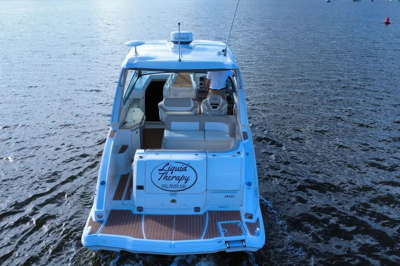 Slide: The Image of 2011 Chaparral 310 Signature boat named "Liquid Therapy" on open water. - 7