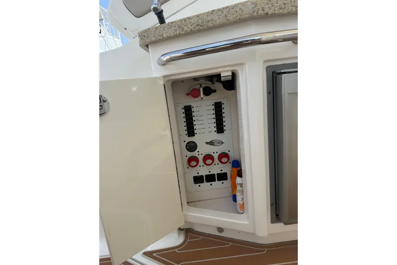 Slide: The Image of Electrical panel inside a 2011 Chaparral 310 Signature boat cabinet. - 21