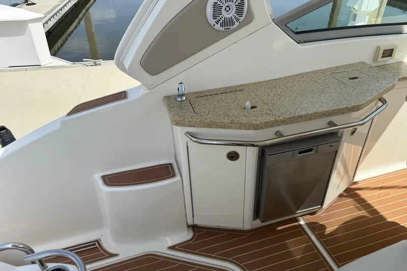 Slide: The Image of 2011 Chaparral 310 Signature boat interior with kitchenette and granite countertop. - 19