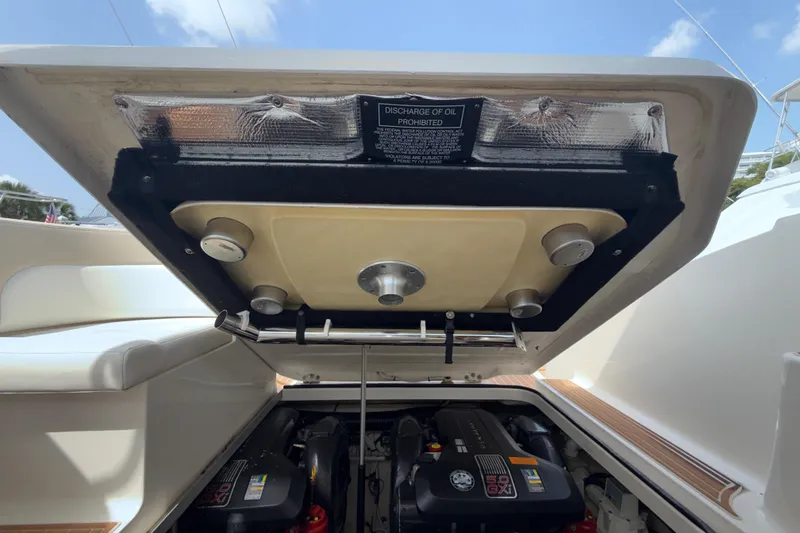 Slide: The Image of Engine compartment of a 2011 Chaparral 310 Signature boat, showcasing dual engines. - 48