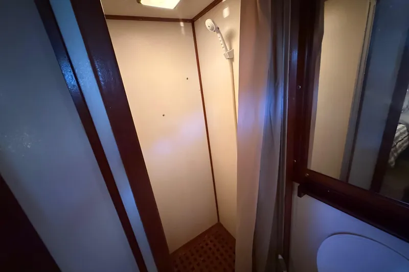 Slide: The Image of Shower area inside a 1989 Heritage East 40 boat, featuring a compact design. - 31