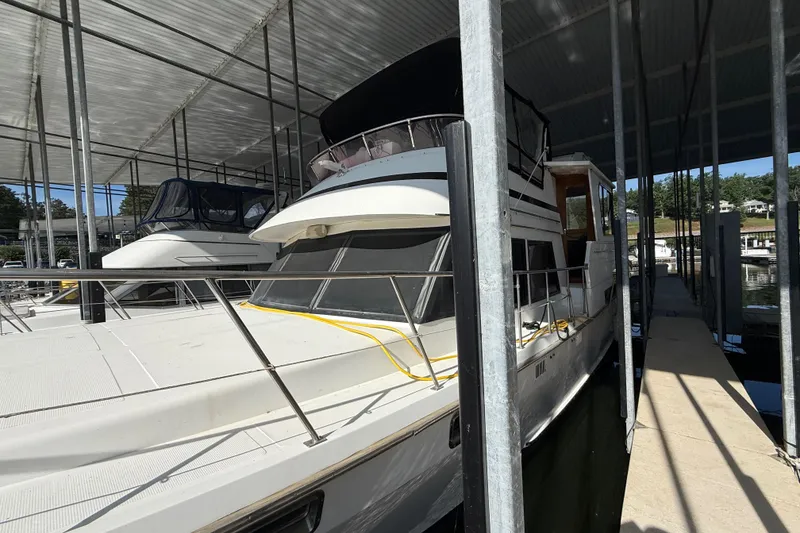 Slide: The Image of 1989 Heritage East 40 yacht docked in a covered marina, side view. - 5
