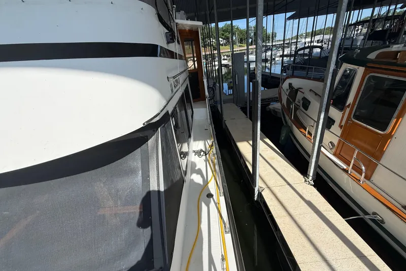 Slide: The Image of 1989 Heritage East 40 yacht docked in a marina, side view with walkway. - 9