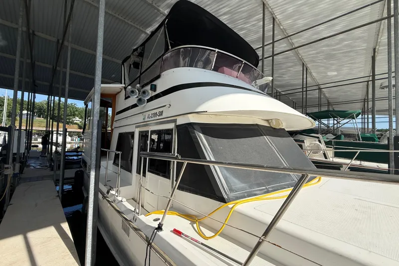 Slide: The Image of 1989 Heritage East 40 yacht docked in a covered marina, featuring a sleek design. - 3