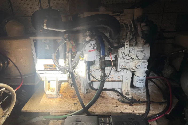 Slide: The Image of Engine room of a 1989 Heritage East 40 boat, featuring a Phasor generator. - 23