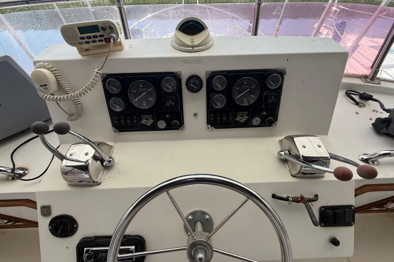 Slide: The Image of Helm of 1989 Heritage East 40 boat with steering wheel, gauges, and radio equipment. - 16