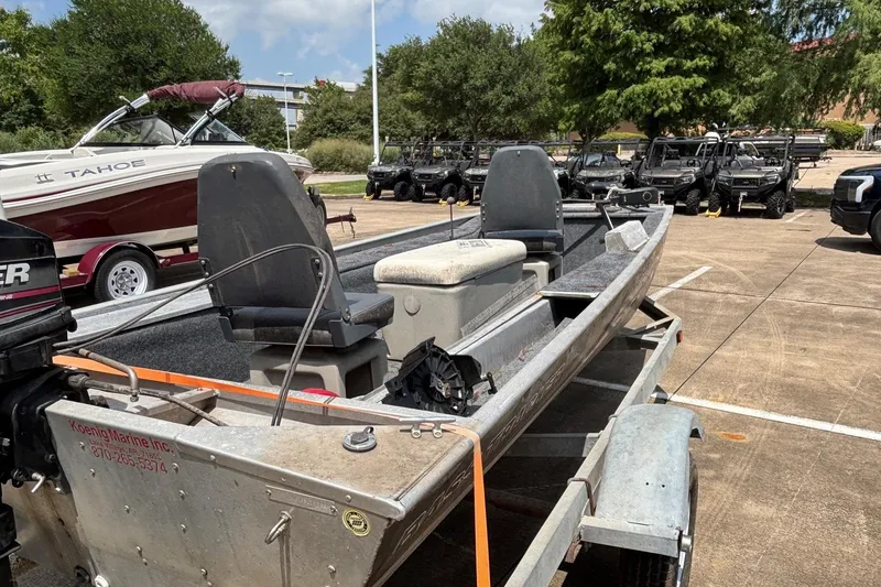 Slide: The Image of 2011 Tracker Panfish 16 boat on trailer in parking lot. - 2