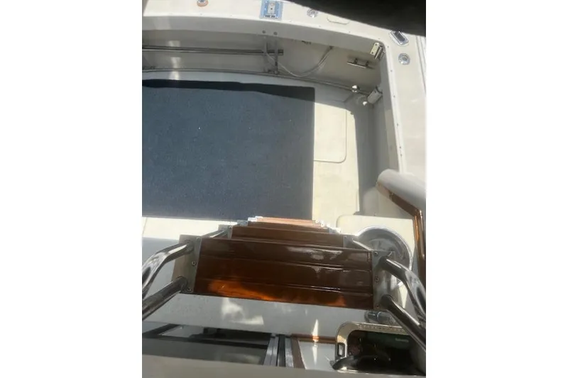 Slide: The Image of 1987 Silverton 34 Convertible boat interior with wooden steps and carpeted floor. - 20