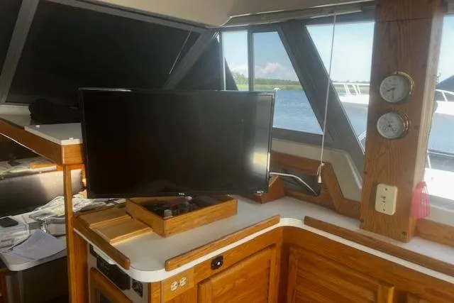 Slide: The Image of Interior of 1987 Silverton 34 Convertible boat with TV and wooden cabinetry. - 26