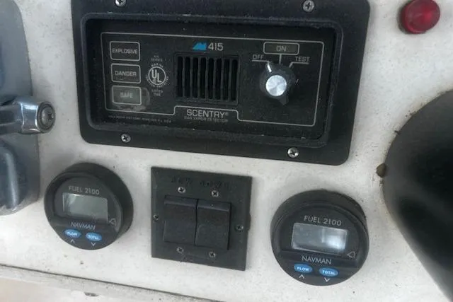 Slide: The Image of Control panel of a 1987 Silverton 34 Convertible boat with fuel gauges and safety switches. - 11