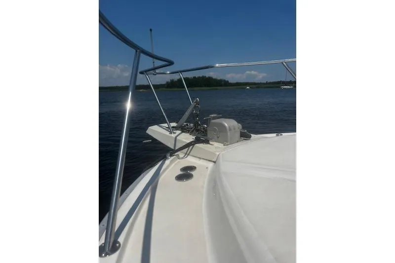 Slide: The Image of 1987 Silverton 34 Convertible boat deck with railing, anchored on a calm lake. - 5