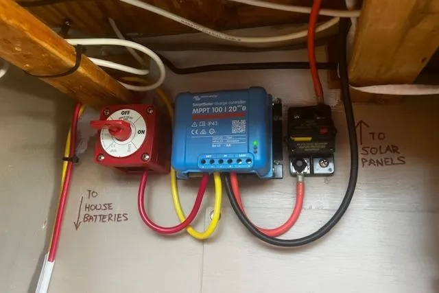 Slide: The Image of Electrical setup in a 1987 Silverton 34 Convertible with solar charge controller and battery connections. - 42