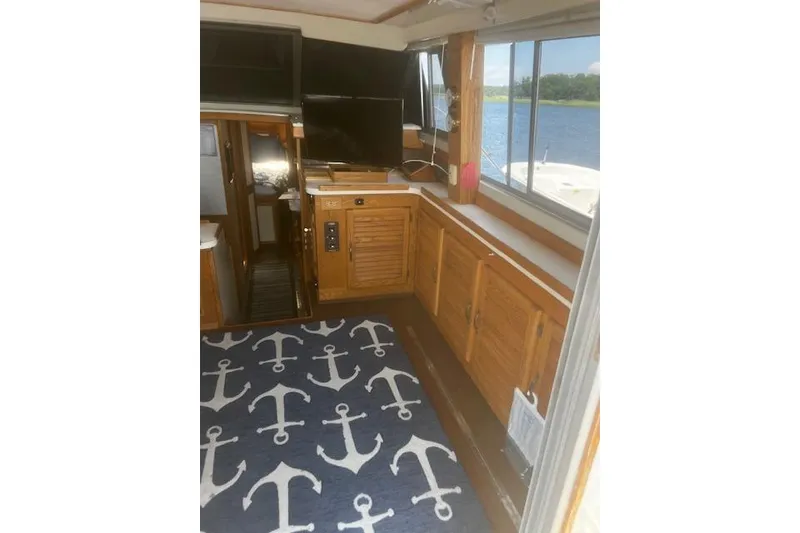 Slide: The Image of Interior of 1987 Silverton 34 Convertible boat with nautical decor and scenic water view. - 28