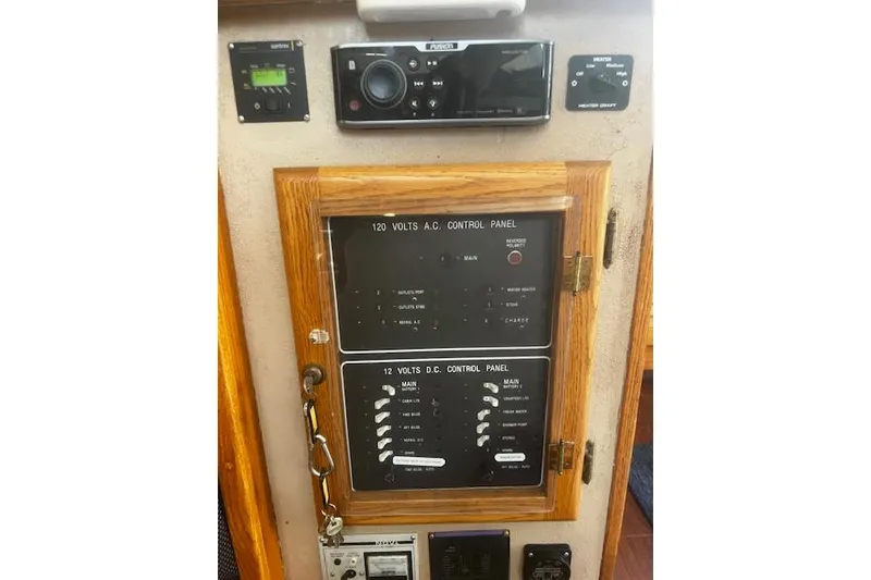 Slide: The Image of 1987 Silverton 34 Convertible control panel with 120V AC and 12V DC systems. - 23