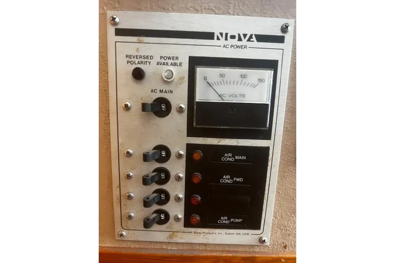 Slide: The Image of 1987 Silverton 34 Convertible AC power panel with voltmeter and switches. - 24