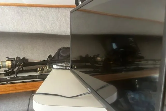 Slide: The Image of 1987 Silverton 34 Convertible interior with fishing rods and a TV screen. - 32