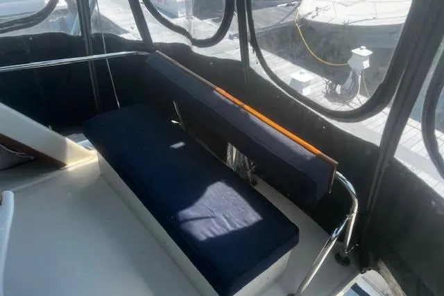 Slide: The Image of 1987 Silverton 34 Convertible boat interior with blue cushioned seating. - 18