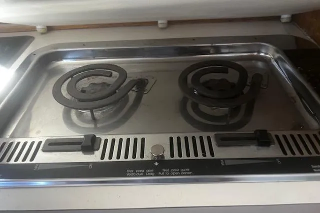 Slide: The Image of 1987 Silverton 34 Convertible stove with two electric burners in a compact kitchen setup. - 34