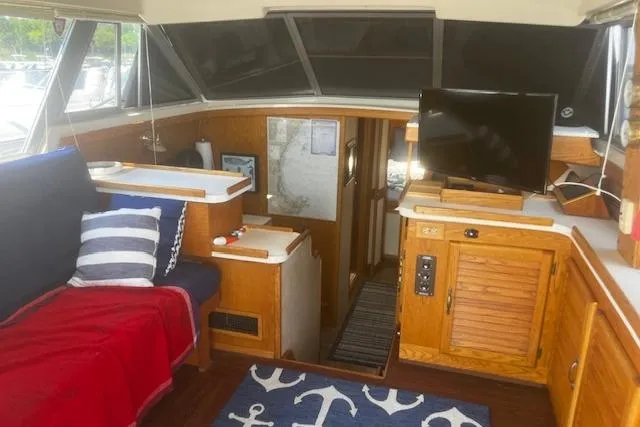 Slide: The Image of Interior of 1987 Silverton 34 Convertible yacht with cozy seating and nautical decor. - 27