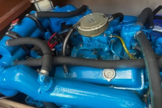 Slide: The Image of 1987 Silverton 34 Convertible engine, vibrant blue, detailed view of components and hoses. - 44