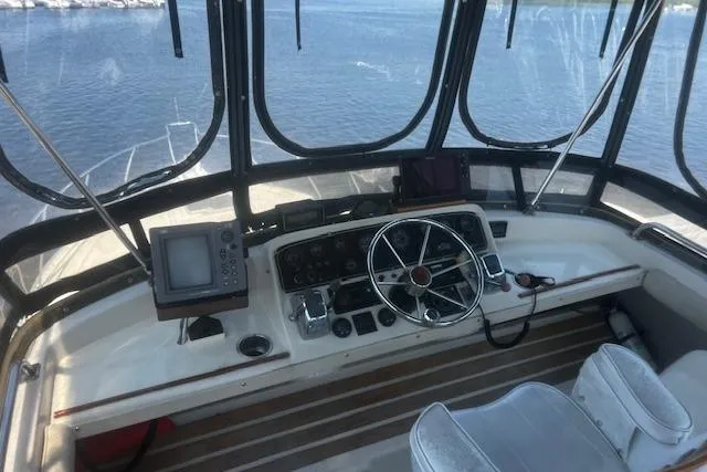 Slide: The Image of 1987 Silverton 34 Convertible boat cockpit with steering wheel and navigation equipment. - 7