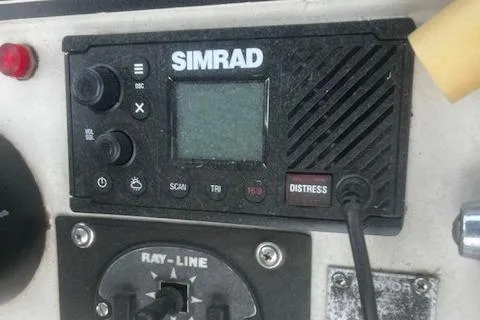 Slide: The Image of Simrad marine radio on 1987 Silverton 34 Convertible boat dashboard. - 9