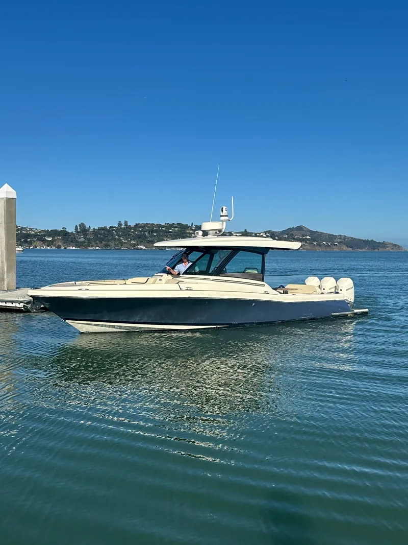Slide: The Image of 2023 Chris-Craft Calypso 35 on calm water, featuring a sleek design and elegant cabin. - 22