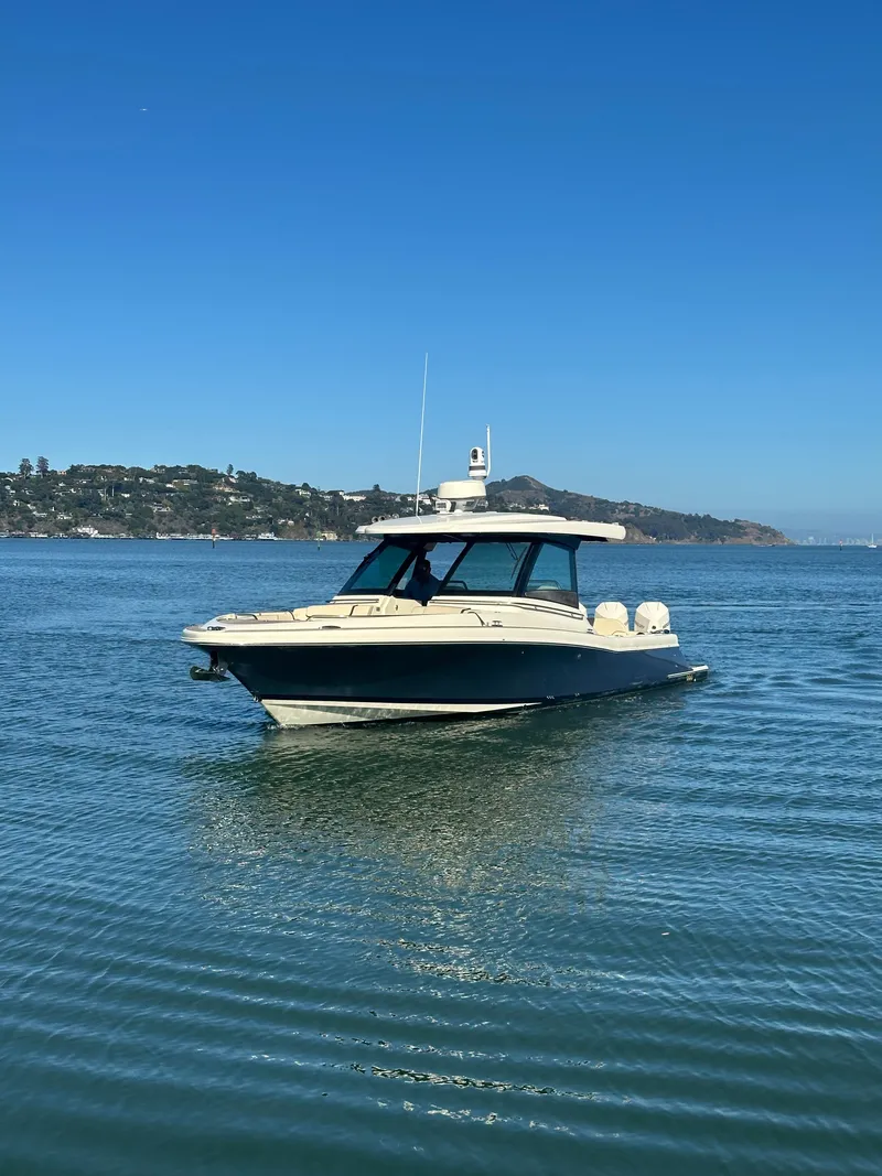 Slide: The Image of 2023 Chris-Craft Calypso 35 on calm water with hills in the background. - 18